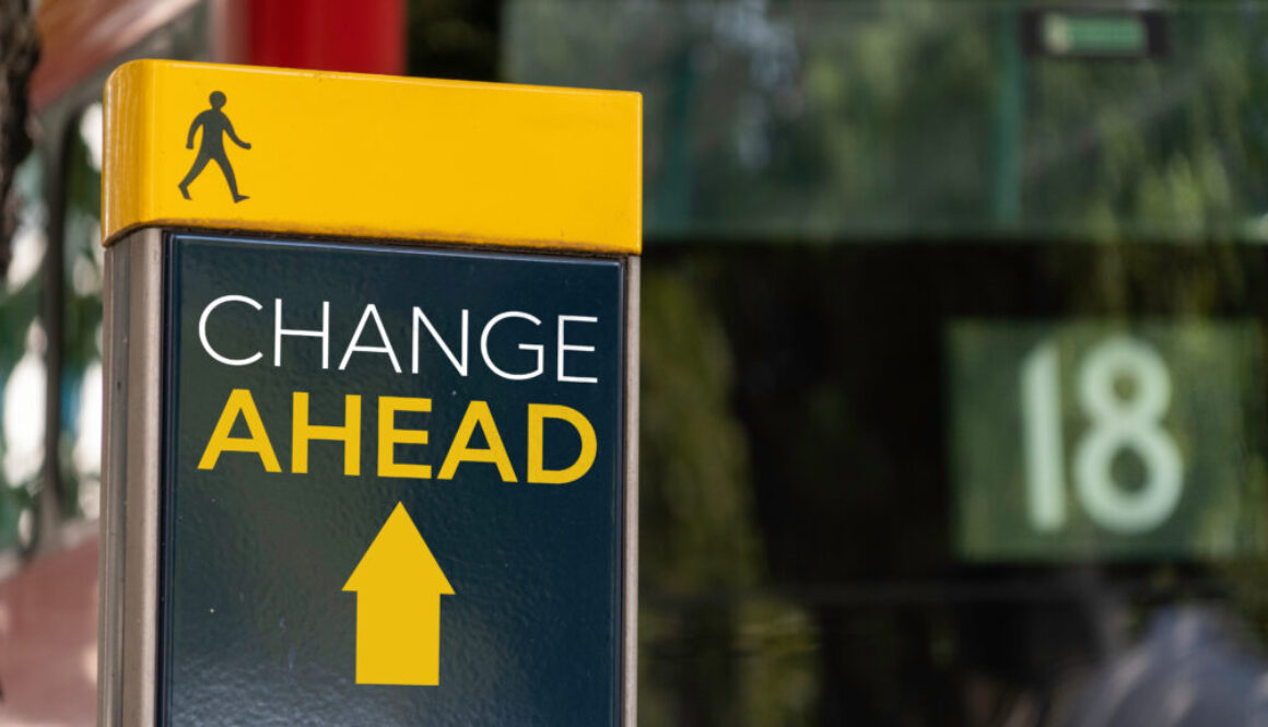 Change Ahead with Arrow sign in a busy commuter city center