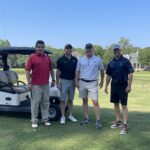 four-men-smiling-golf-cart