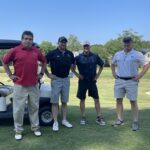 four-men-smiling-golf-course