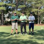 three-men-holding-golf-clubs