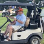 man-smiling-in-golf-caddy