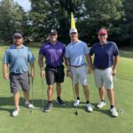 four-men-on-golf-course