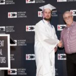 graduate-shaking-mans-hand