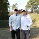 two-men-smiling-golf-clubs