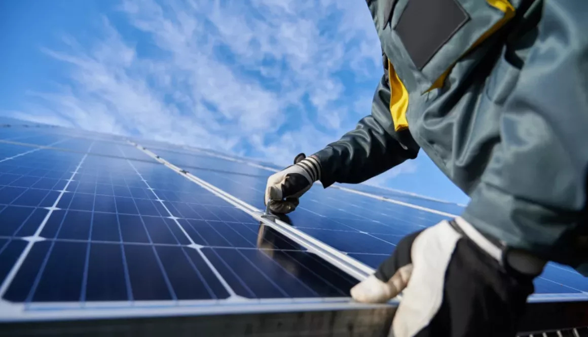 man-working-on-solar-panel